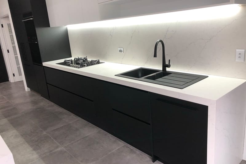Black cabinetry, white stone benchtop